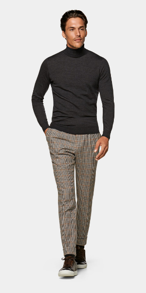 model in grey roll neck and check trousers