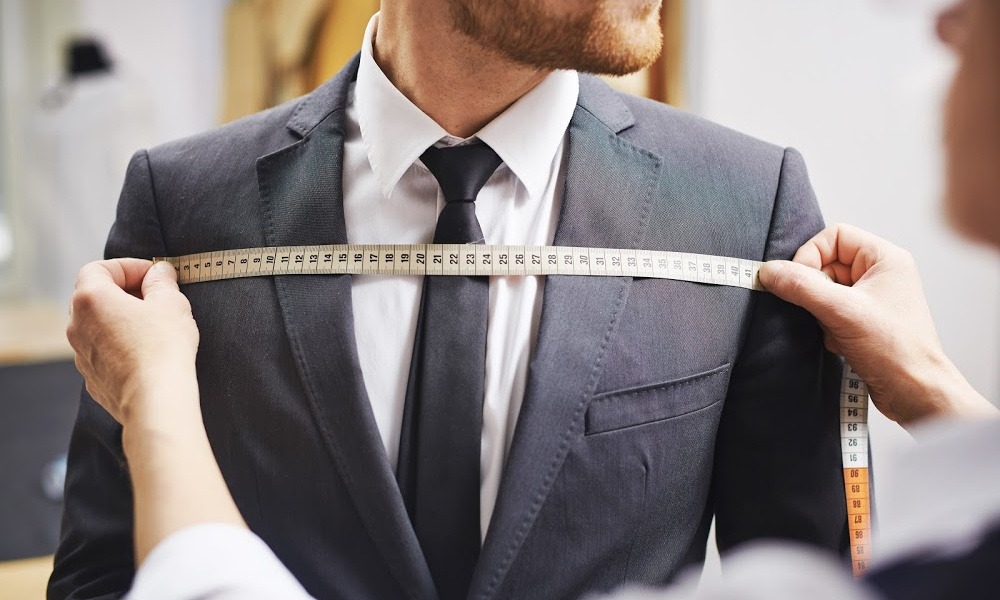 tailor measuring a business suit