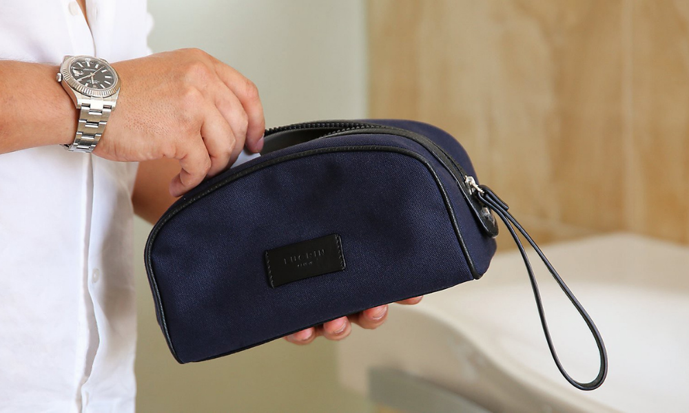 man with small toiletries bag