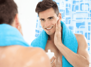 man applying aftershave
